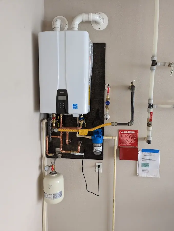 Professional plumber installing copper piping in a Kittery home